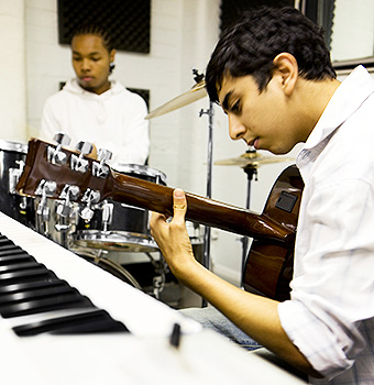 Young musicians play the guitar and drums together