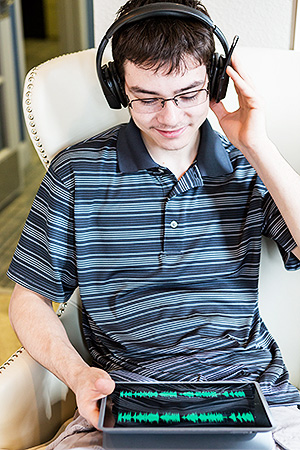 Young man listening to music on a tablet